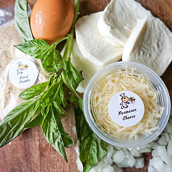 Basil, egg and parmesan cheese on counter