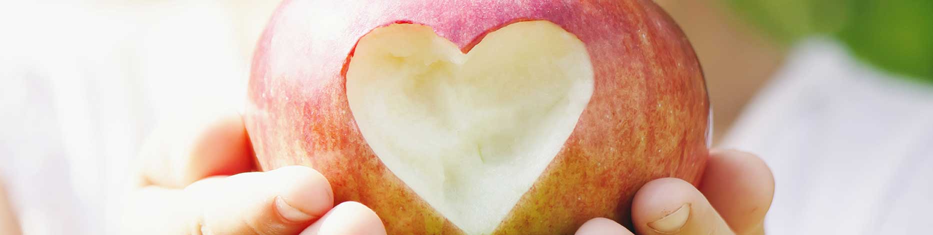 Apple with heart shape carved in it symbolizing community care