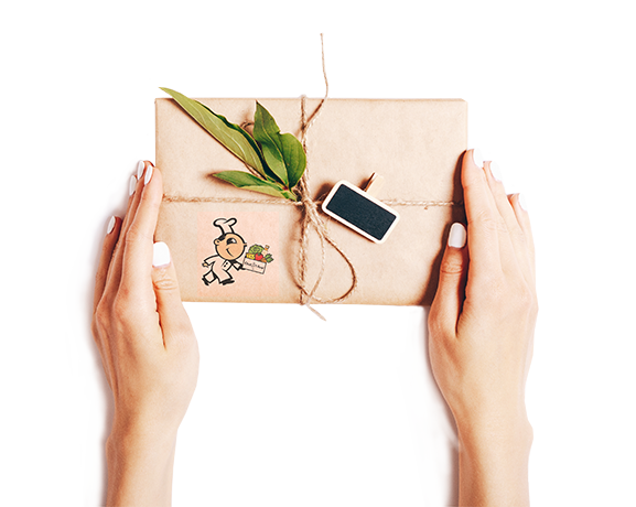 Hands holding a Chef Ami gift box with fresh ingredients